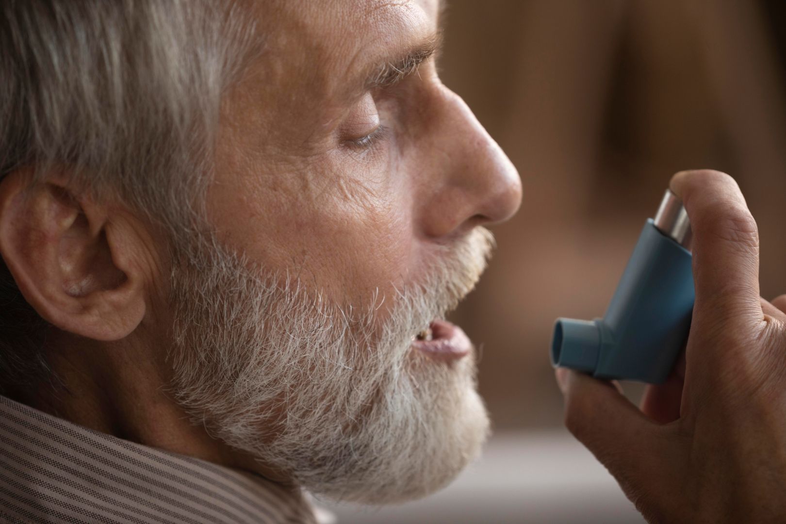 close-up-elderly-man-holding-asthma-inhaler 2.jpg